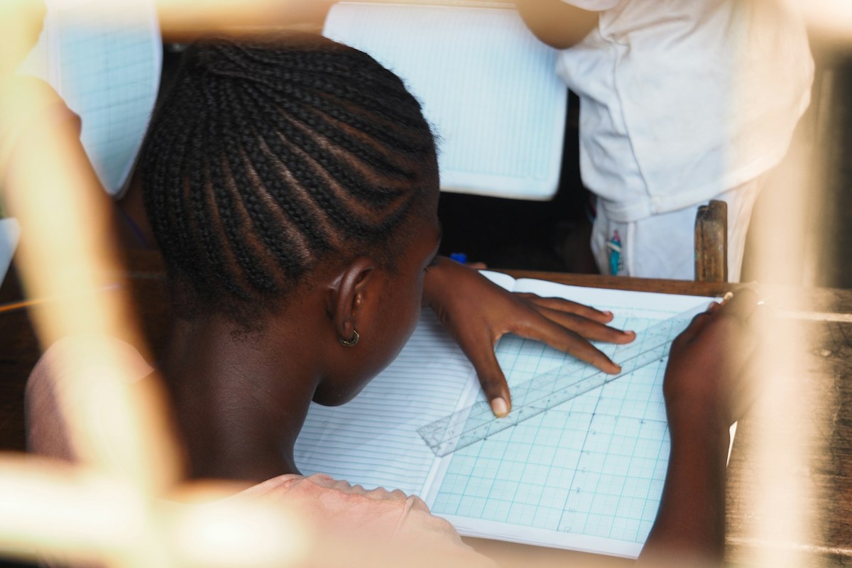 Jeune écolière au Ghana s'exerçant en mathématiques
